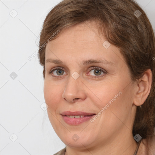 Joyful white adult female with medium  brown hair and grey eyes