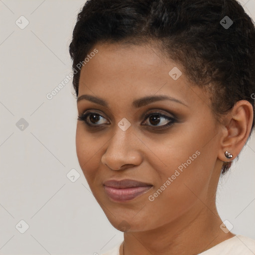 Joyful black young-adult female with short  brown hair and brown eyes