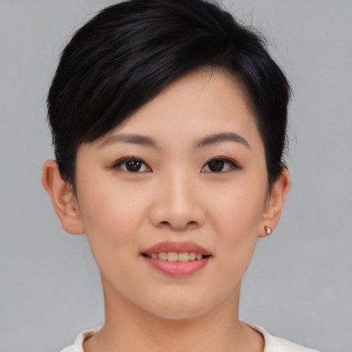 Joyful asian young-adult female with short  black hair and brown eyes
