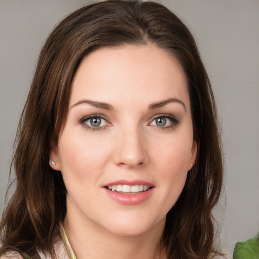 Joyful white young-adult female with medium  brown hair and green eyes