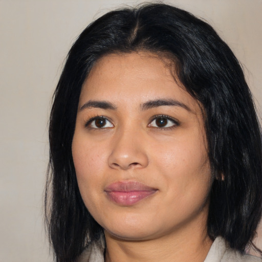 Joyful asian young-adult female with medium  black hair and brown eyes