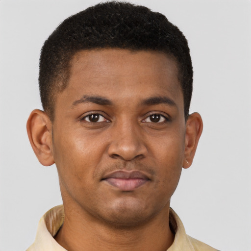 Joyful black young-adult male with short  brown hair and brown eyes