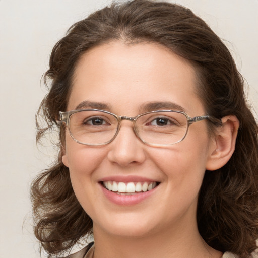 Joyful white young-adult female with long  brown hair and green eyes