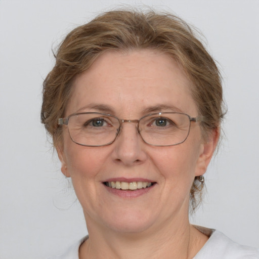 Joyful white adult female with medium  brown hair and blue eyes