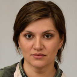 Joyful white young-adult female with medium  brown hair and brown eyes