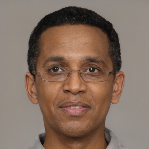 Joyful latino adult male with short  black hair and brown eyes