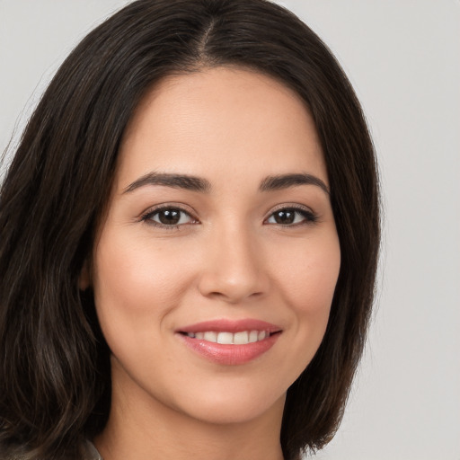 Joyful white young-adult female with long  brown hair and brown eyes