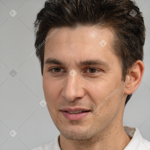 Joyful white adult male with short  brown hair and brown eyes