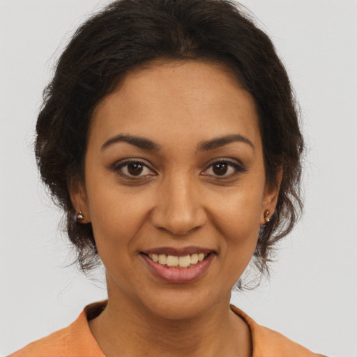 Joyful latino young-adult female with long  brown hair and brown eyes