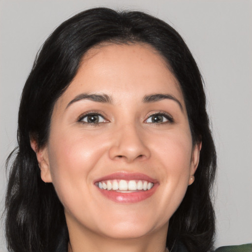 Joyful white young-adult female with long  black hair and brown eyes