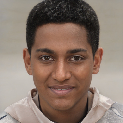 Joyful black young-adult male with short  brown hair and brown eyes