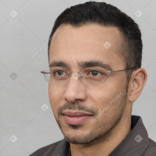 Joyful white adult male with short  black hair and brown eyes