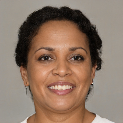 Joyful black adult female with short  brown hair and brown eyes