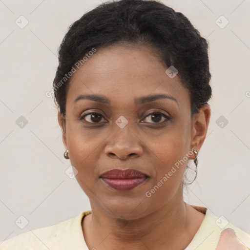 Joyful black adult female with short  brown hair and brown eyes