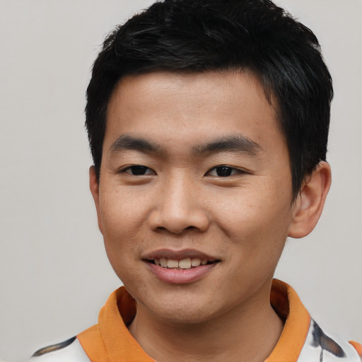 Joyful asian young-adult male with short  black hair and brown eyes