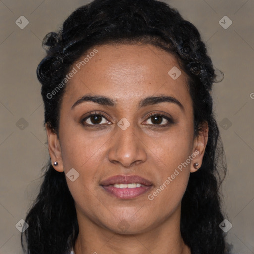 Joyful black young-adult female with long  black hair and brown eyes