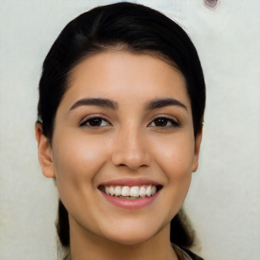 Joyful white young-adult female with long  brown hair and brown eyes