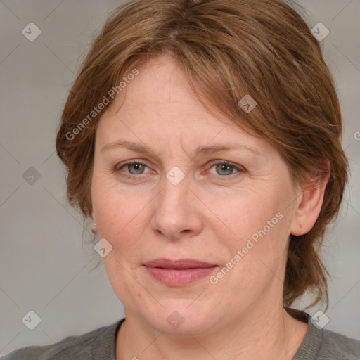 Joyful white adult female with medium  brown hair and blue eyes