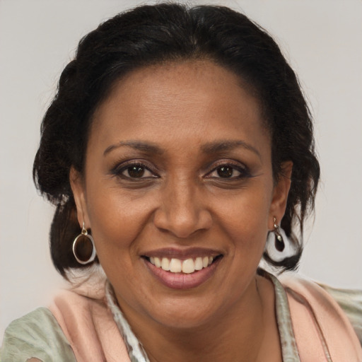 Joyful latino adult female with medium  brown hair and brown eyes