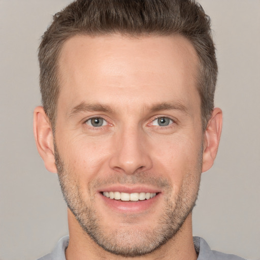 Joyful white adult male with short  brown hair and brown eyes