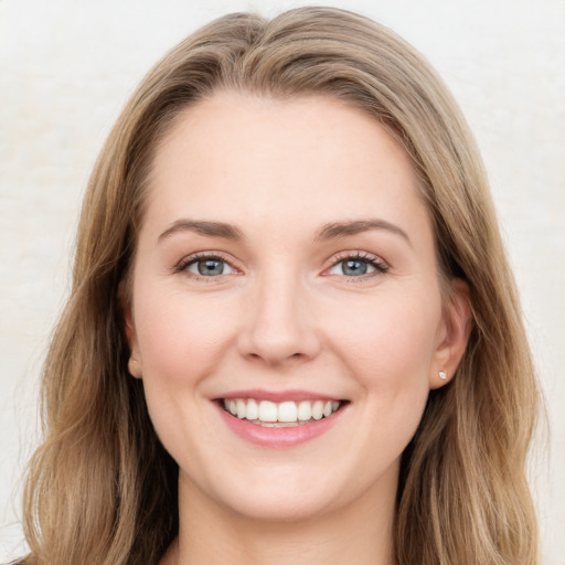 Joyful white young-adult female with long  brown hair and green eyes