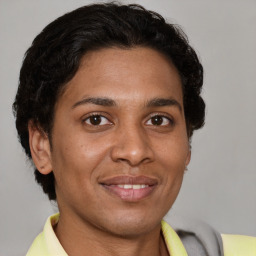 Joyful latino young-adult male with short  brown hair and brown eyes