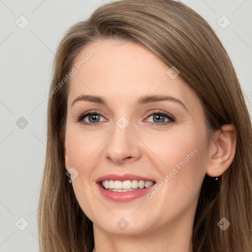 Joyful white young-adult female with long  brown hair and grey eyes