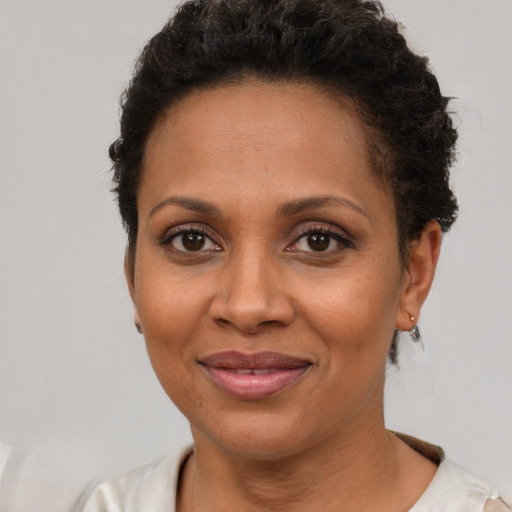Joyful latino young-adult female with short  brown hair and brown eyes