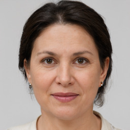 Joyful white adult female with medium  brown hair and brown eyes