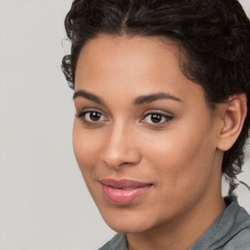 Joyful latino young-adult female with short  brown hair and brown eyes