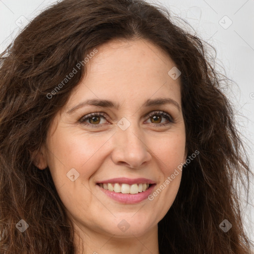 Joyful white adult female with long  brown hair and brown eyes