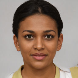 Joyful latino young-adult female with short  brown hair and brown eyes