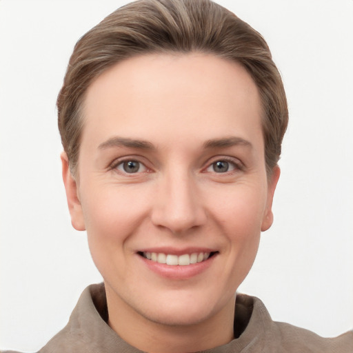 Joyful white young-adult female with short  brown hair and grey eyes